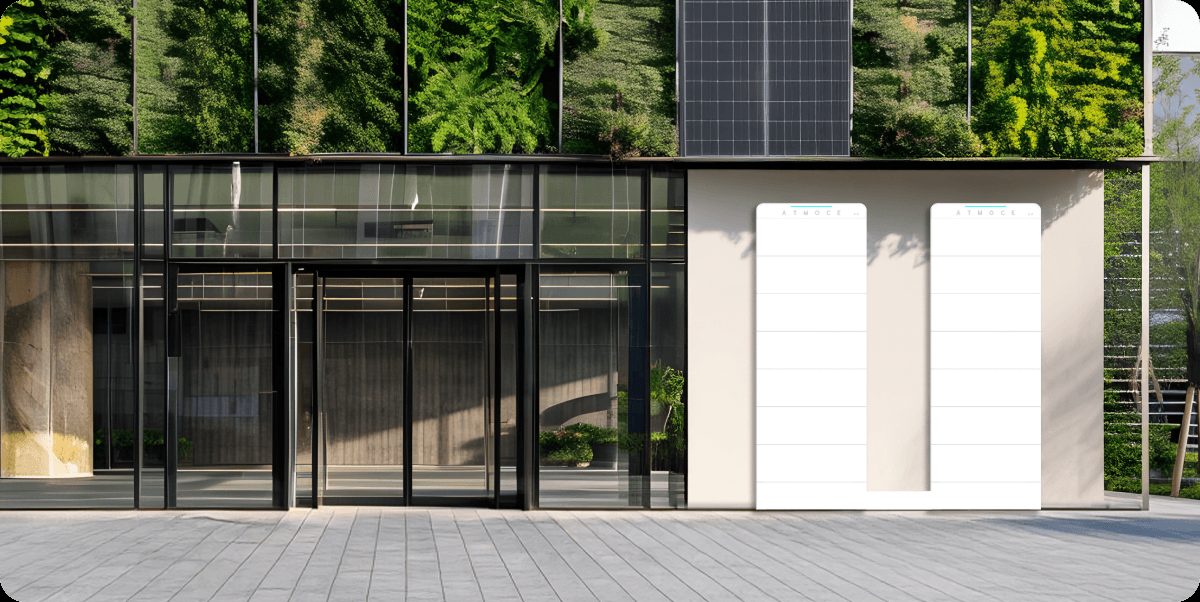 ATMOCE M-ELV BattBank battery system next to an office building with solar panels